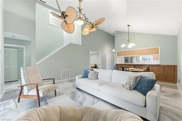 a living room with furniture chandelier and a chandelier