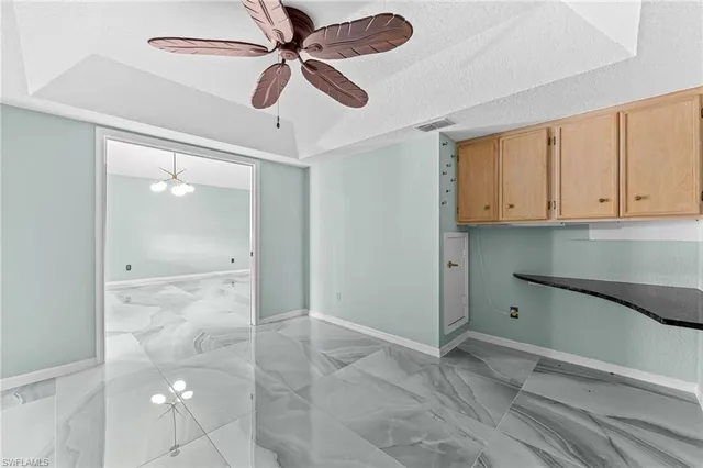a view of a kitchen with a sink and cabinets