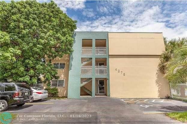 4301 Northwest S Tamiami Canal Drive, Unit 3214 Miami, FL 33126 - Photo 1 of 1 a view of building with car parked