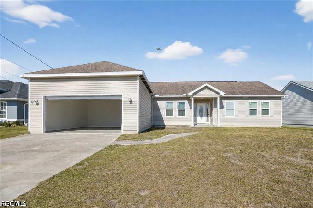 2808 34th Street Southwest Lehigh Acres, FL 33976 - Photo 1 of 14 a view of house with yard and garage