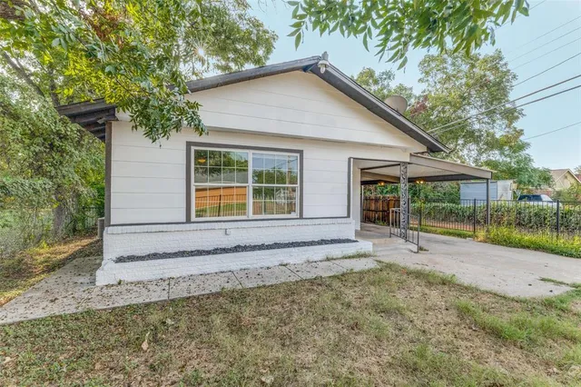 a view of house with backyard and glass windows