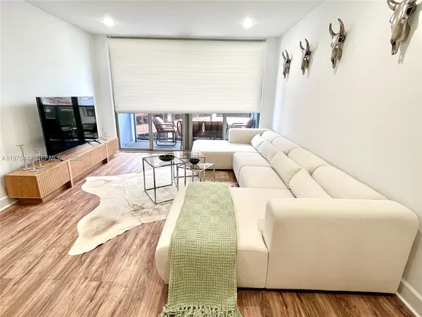 a living room with furniture and a flat screen tv