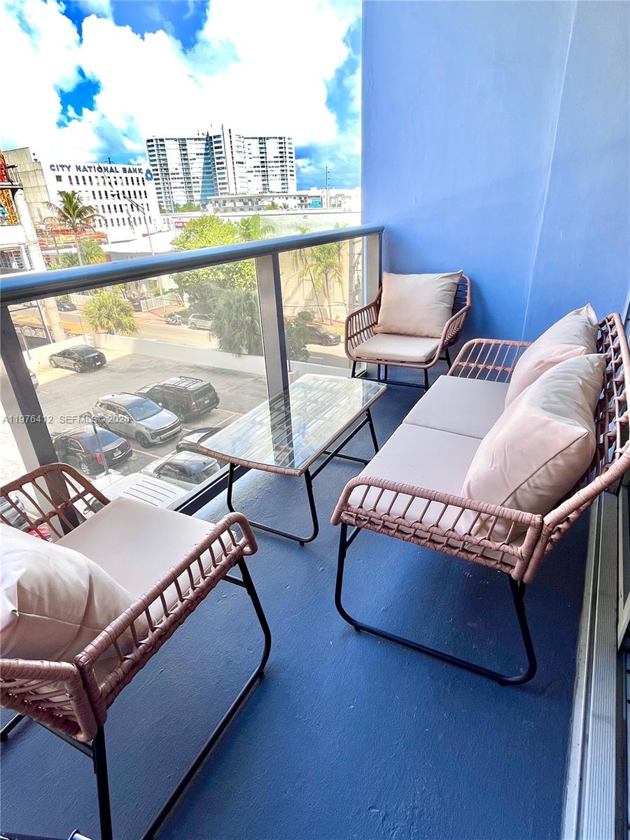 401 69th Street, Unit 405 Miami Beach, FL 33141 - Photo 12 of 20 a living room with furniture and a large window