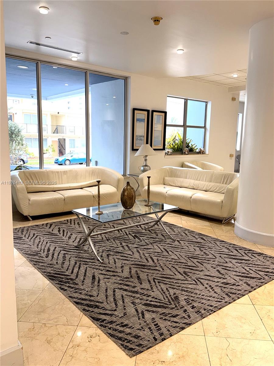 401 69th Street, Unit 405 Miami Beach, FL 33141 - Photo 14 of 20 a living room with a bed