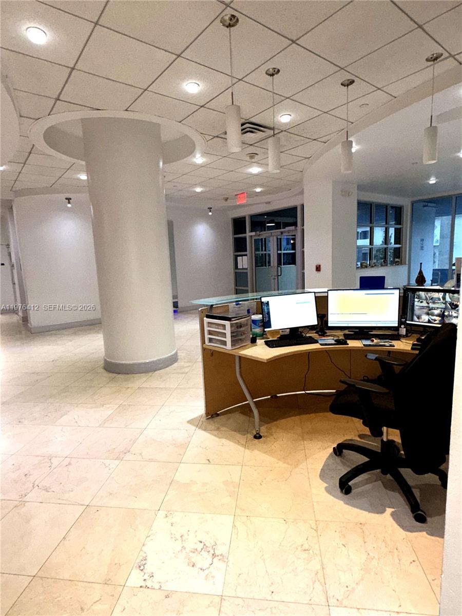 401 69th Street, Unit 405 Miami Beach, FL 33141 - Photo 16 of 20 a living room with lots of furniture and kitchen view