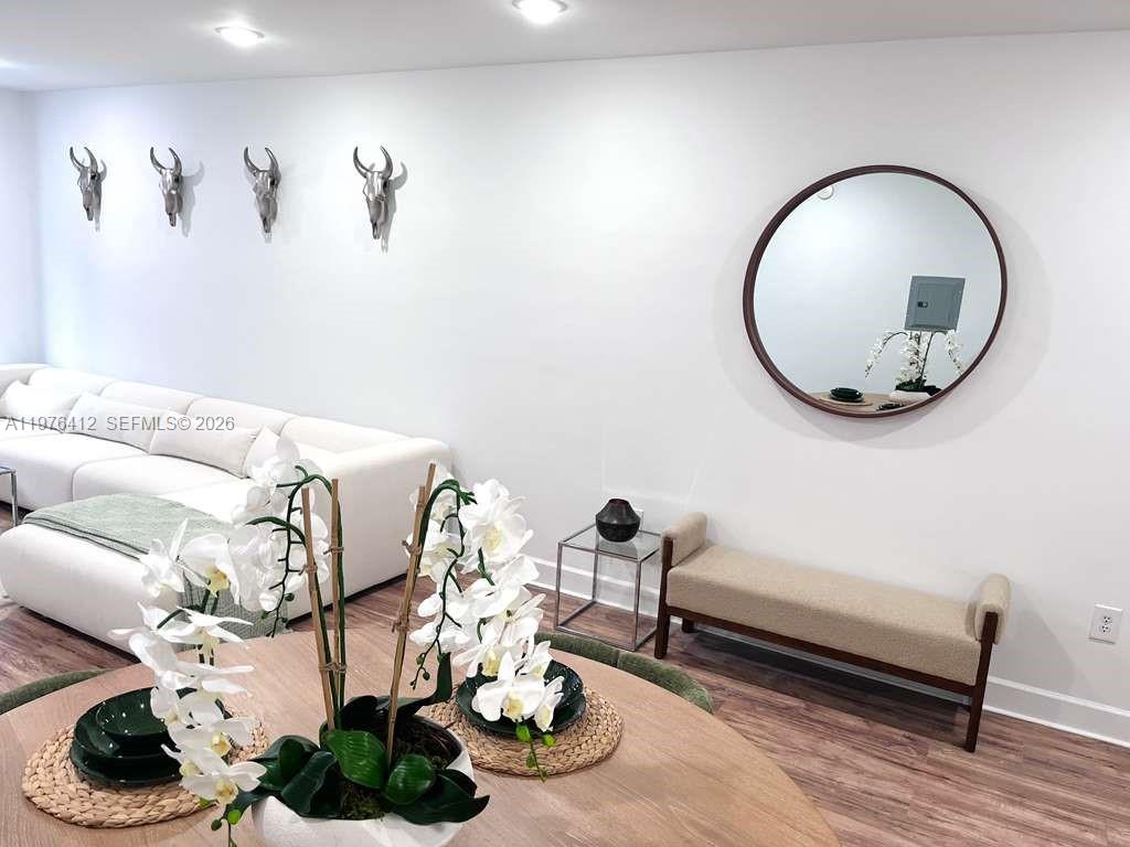 401 69th Street, Unit 405 Miami Beach, FL 33141 - Photo 3 of 20 a living room with furniture and a mirror