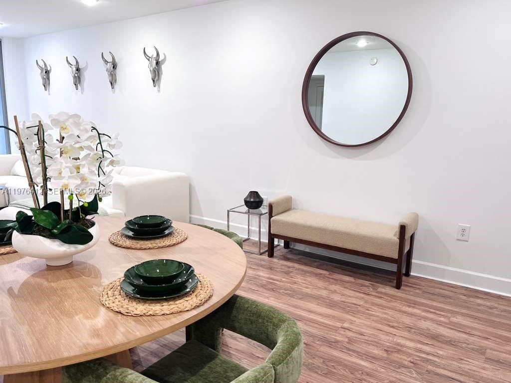 401 69th Street, Unit 405 Miami Beach, FL 33141 - Photo 4 of 20 a living room with furniture and a mirror