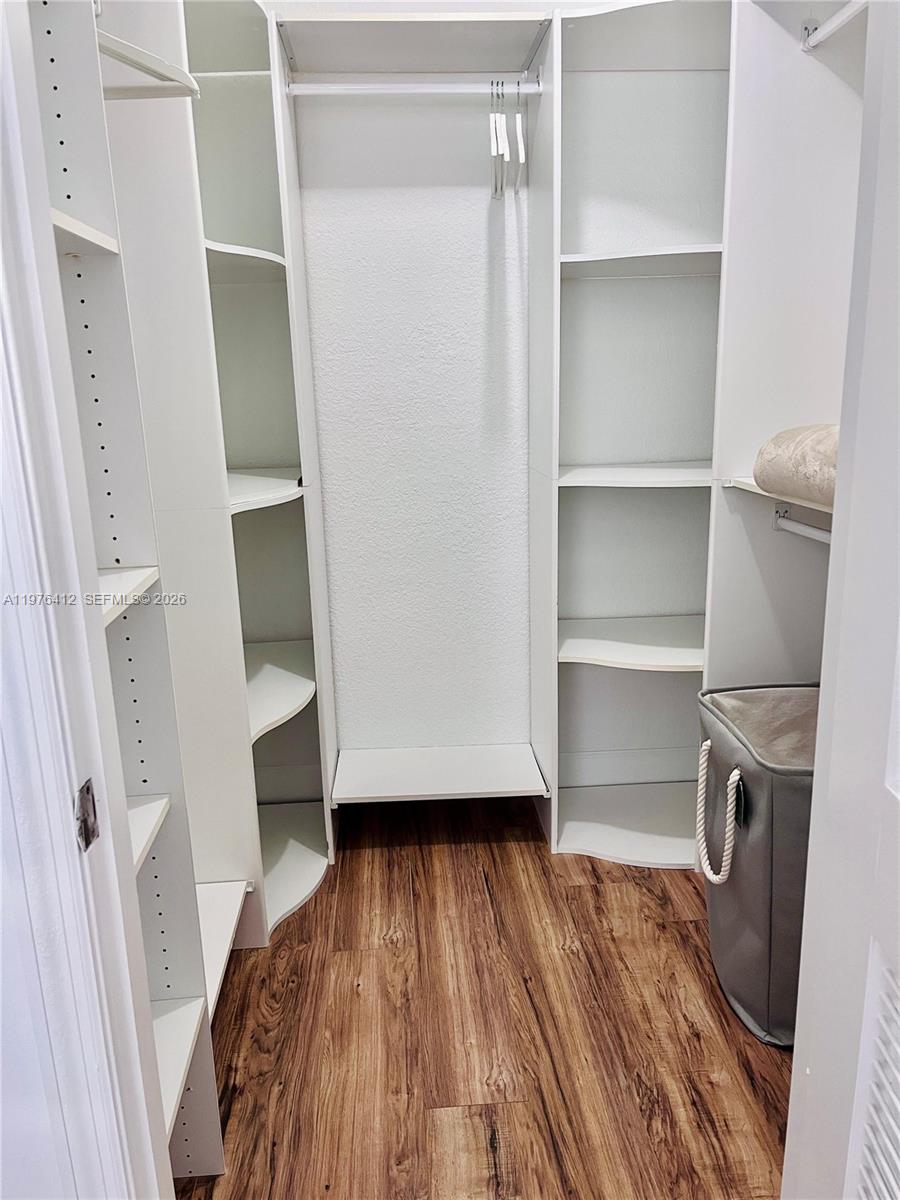 401 69th Street, Unit 405 Miami Beach, FL 33141 - Photo 8 of 20 a view of walk in closet with empty racks