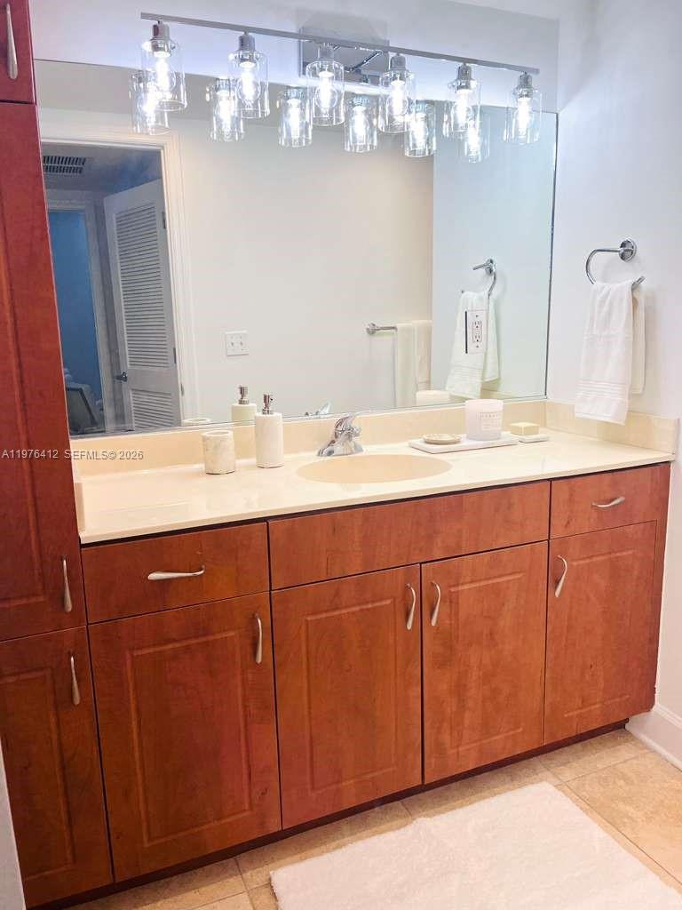 401 69th Street, Unit 405 Miami Beach, FL 33141 - Photo 10 of 20 a bathroom with a sink double vanity and a mirror