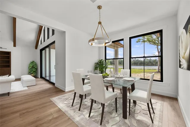 a view of an empty room with wooden floor and a fireplace