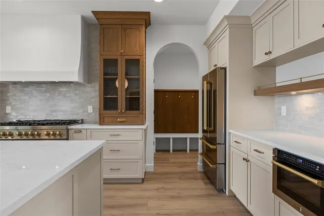a large kitchen with cabinets a sink and appliances