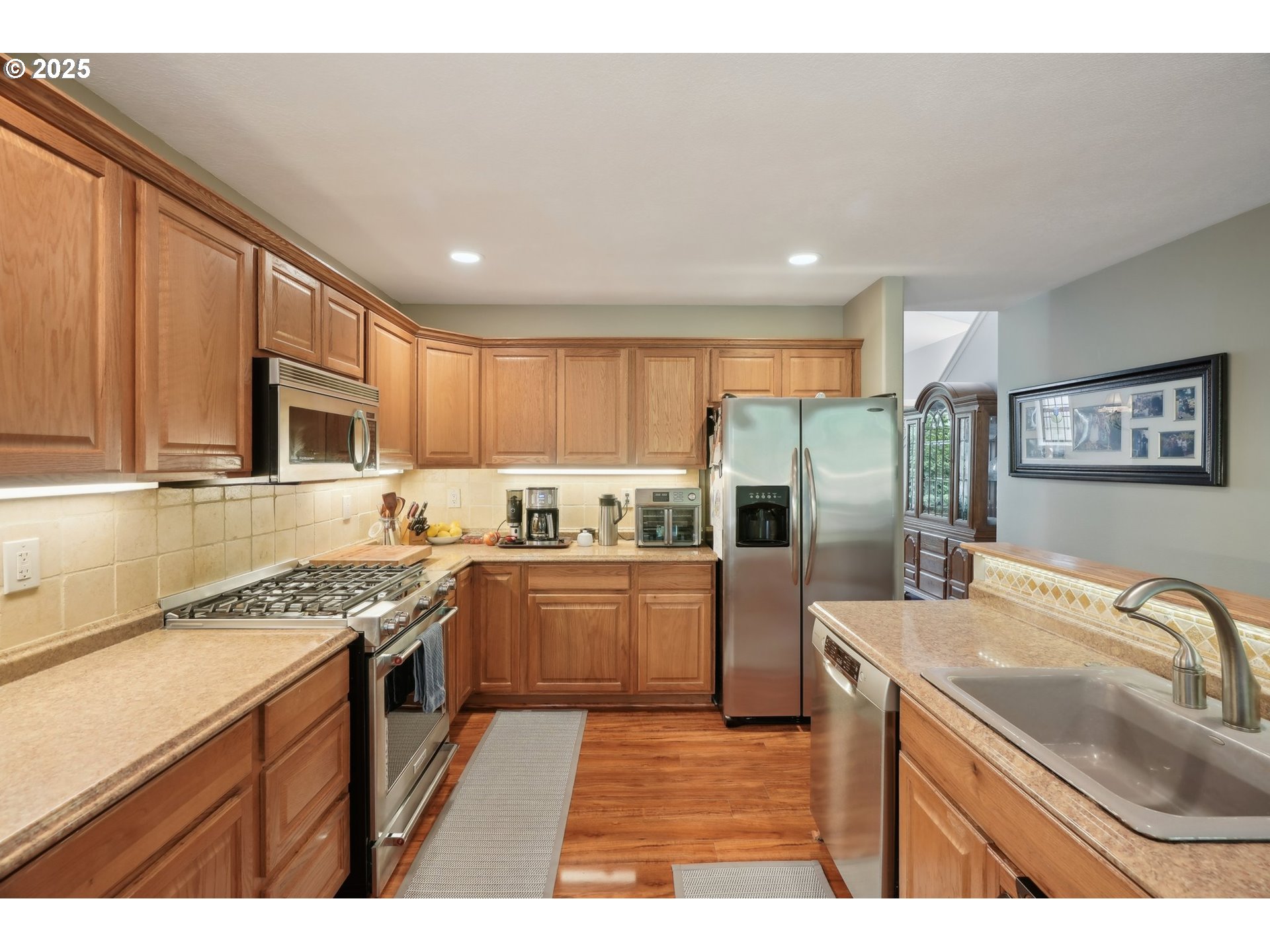 4709 Southeast Antelope Hills Gresham, OR 97080 - Photo 13 of 48 a kitchen with stainless steel appliances granite countertop a sink stove microwave and refrigerator