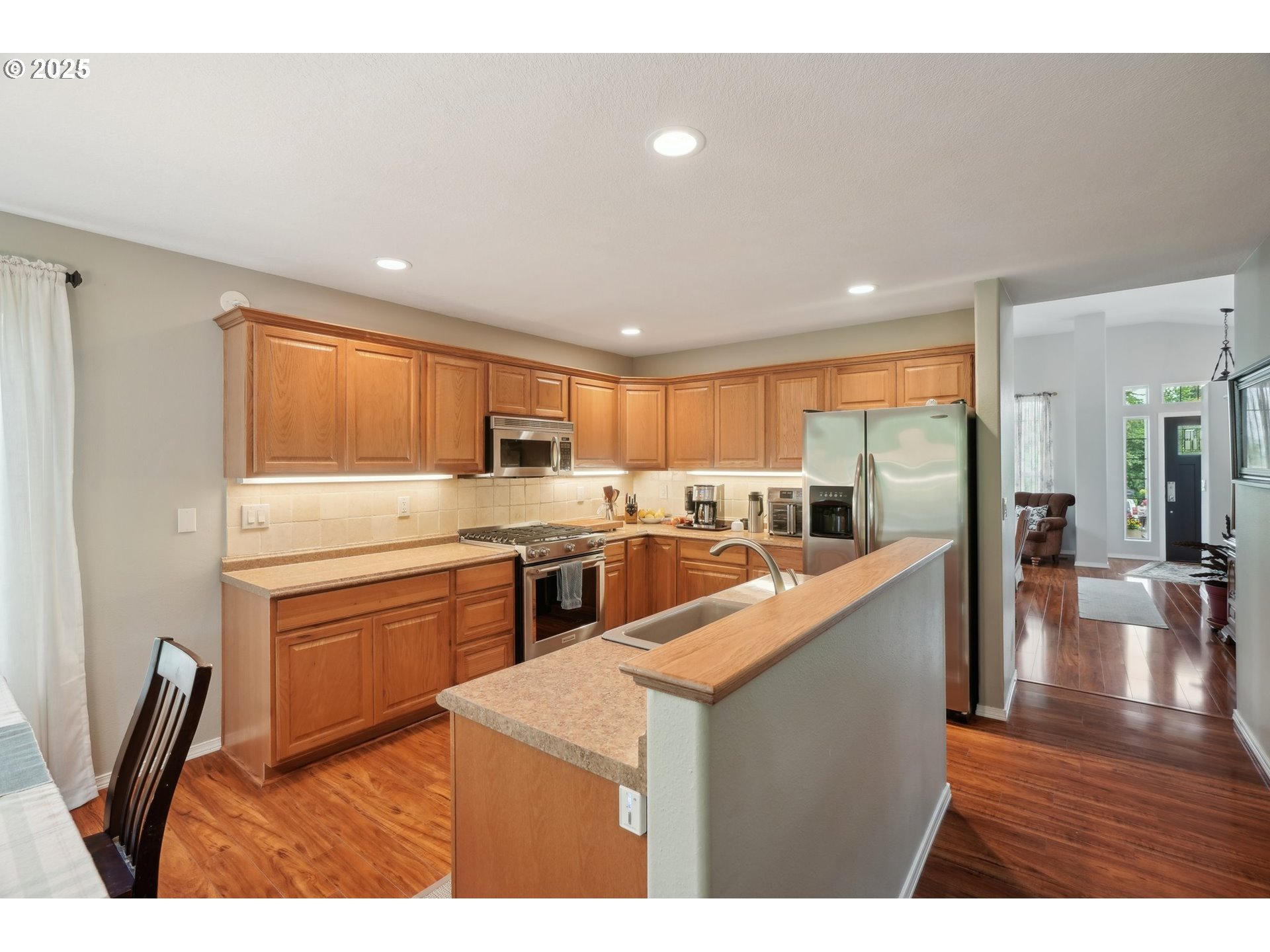 4709 Southeast Antelope Hills Gresham, OR 97080 - Photo 14 of 48 a large kitchen with stainless steel appliances kitchen island granite countertop a large counter top and a stove