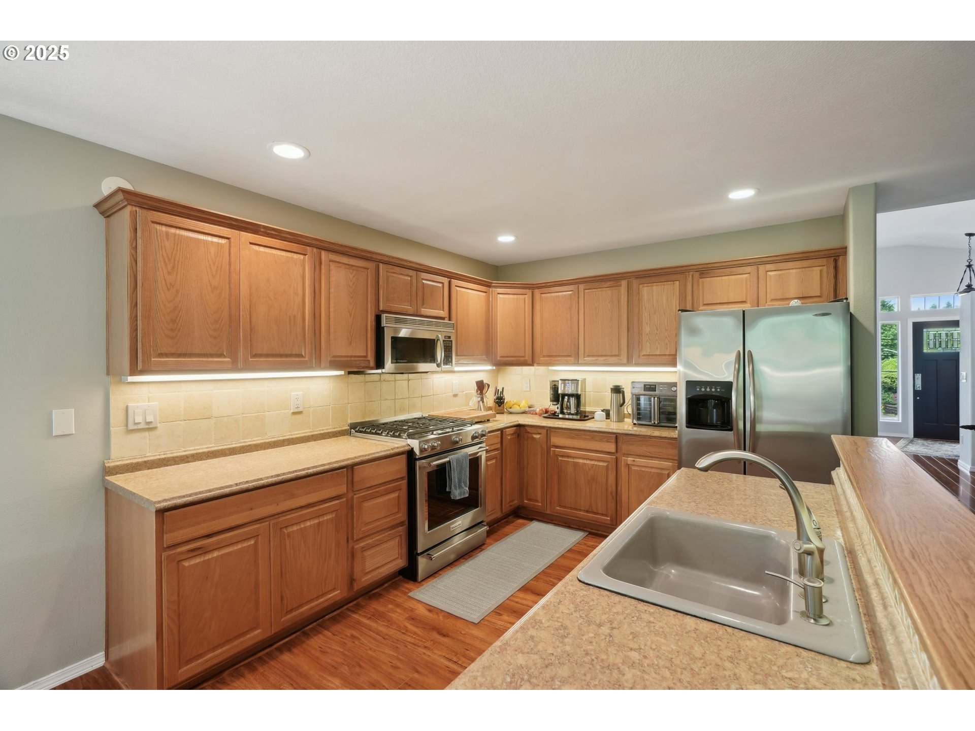 4709 Southeast Antelope Hills Gresham, OR 97080 - Photo 18 of 48 a kitchen with stainless steel appliances granite countertop a refrigerator a sink dishwasher a stove with wooden cabinets and floor