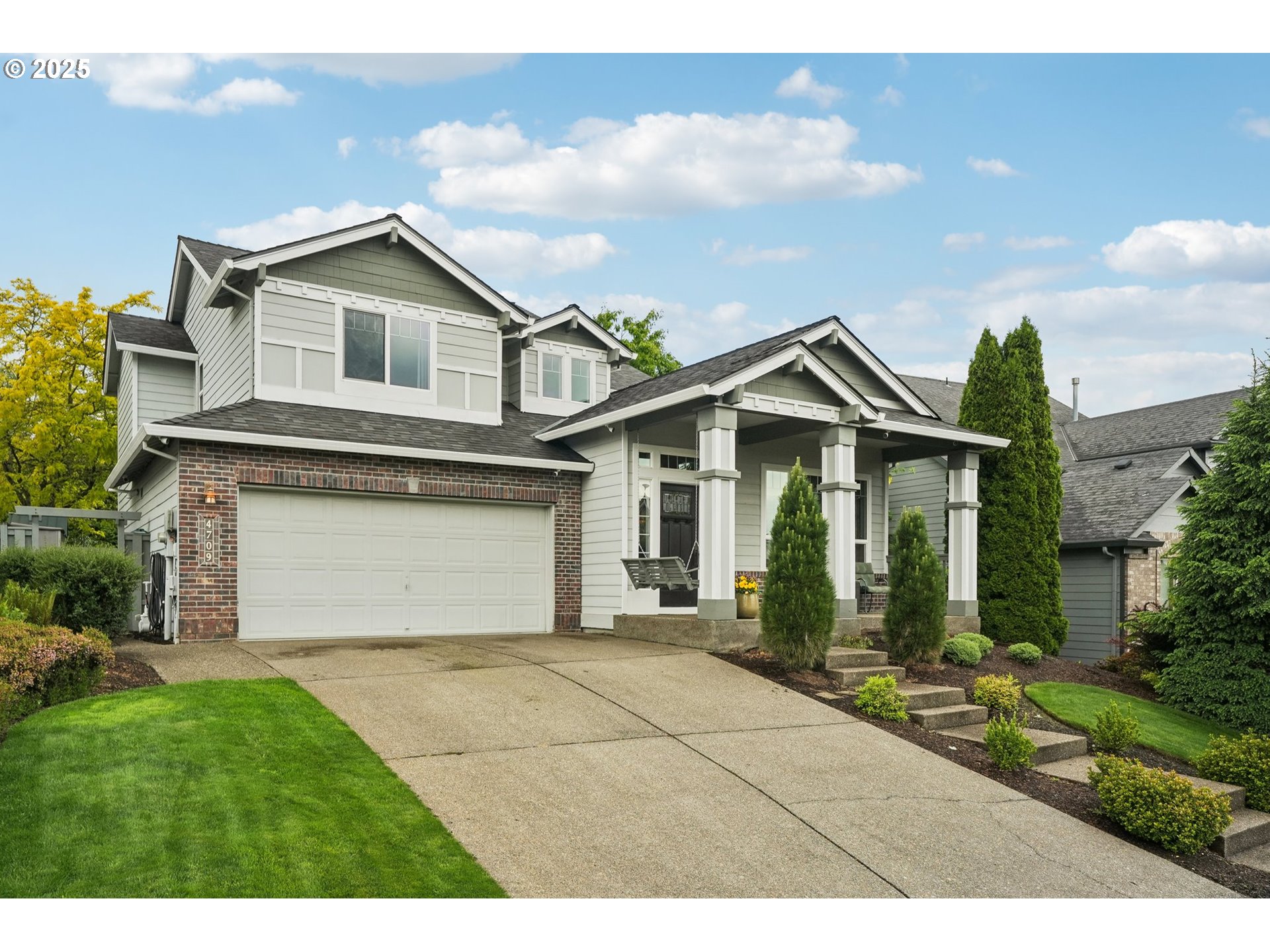 4709 Southeast Antelope Hills Gresham, OR 97080 - Photo 2 of 48 a front view of a house with a yard and garage