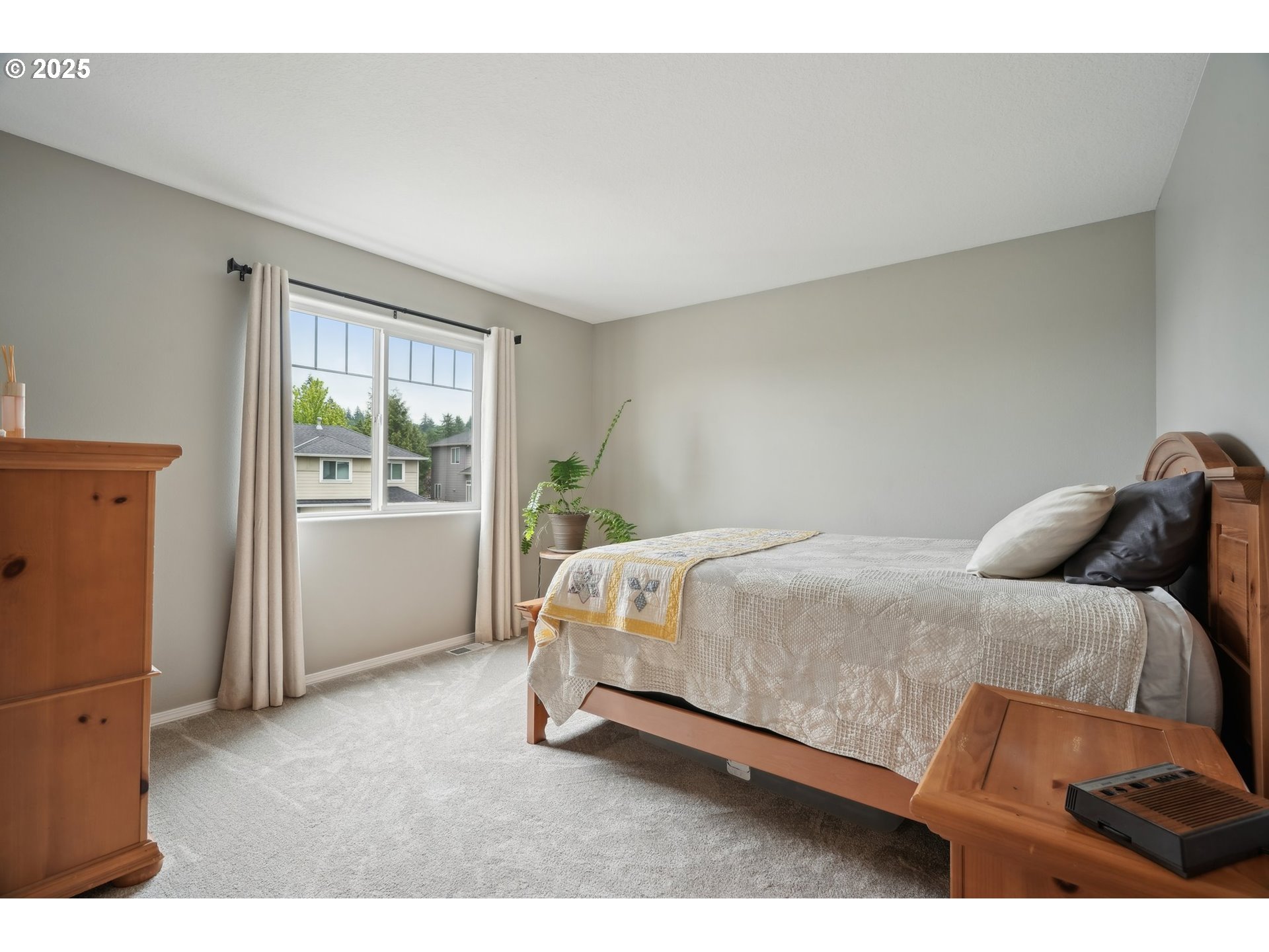 4709 Southeast Antelope Hills Gresham, OR 97080 - Photo 31 of 48 a bed sitting in a bedroom next to a window
