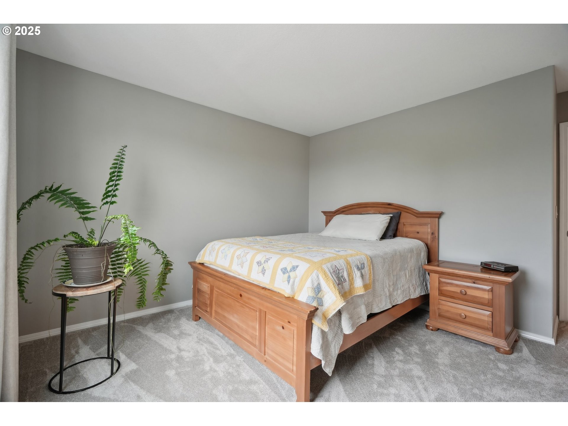 4709 Southeast Antelope Hills Gresham, OR 97080 - Photo 32 of 48 a bedroom with a bed lamp and a potted plant