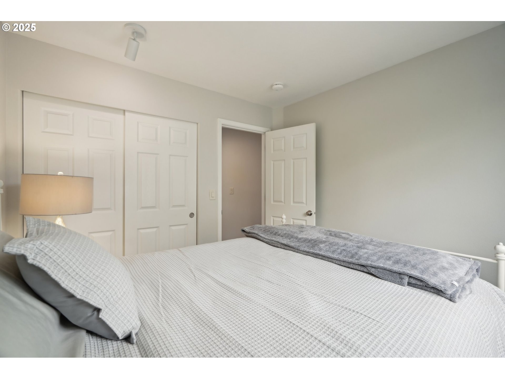 4709 Southeast Antelope Hills Gresham, OR 97080 - Photo 37 of 48 a bedroom with a bed and a lamp