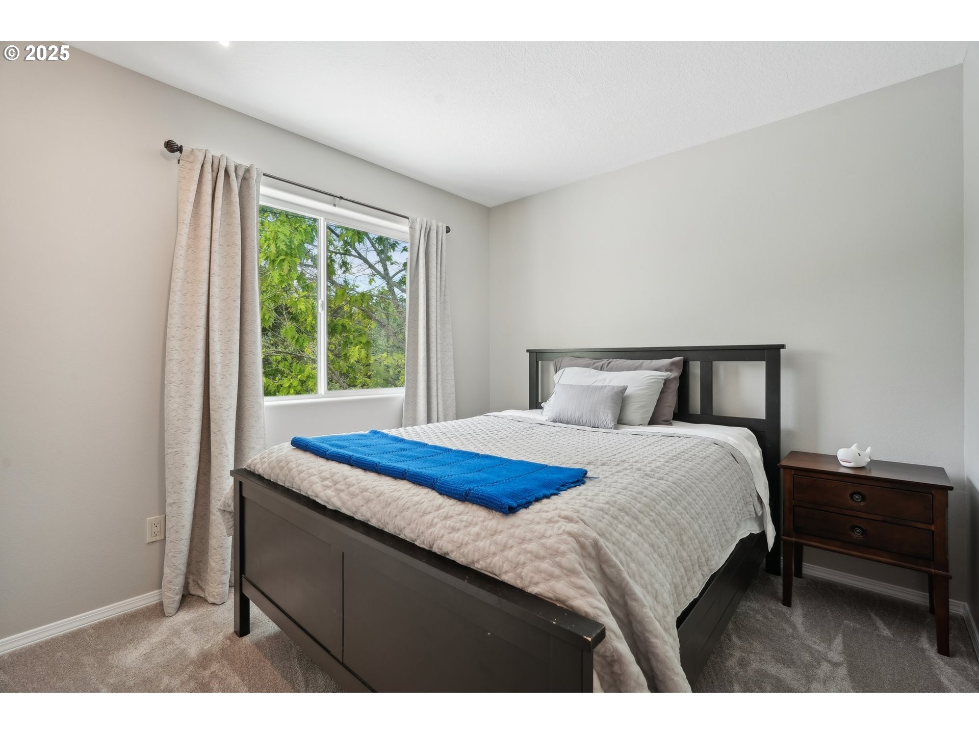 4709 Southeast Antelope Hills Gresham, OR 97080 - Photo 38 of 48 a bedroom with a bed a window and a lamp