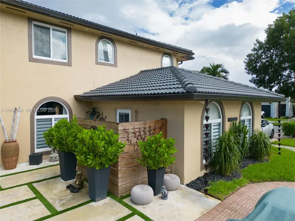 a front view of a house with garden