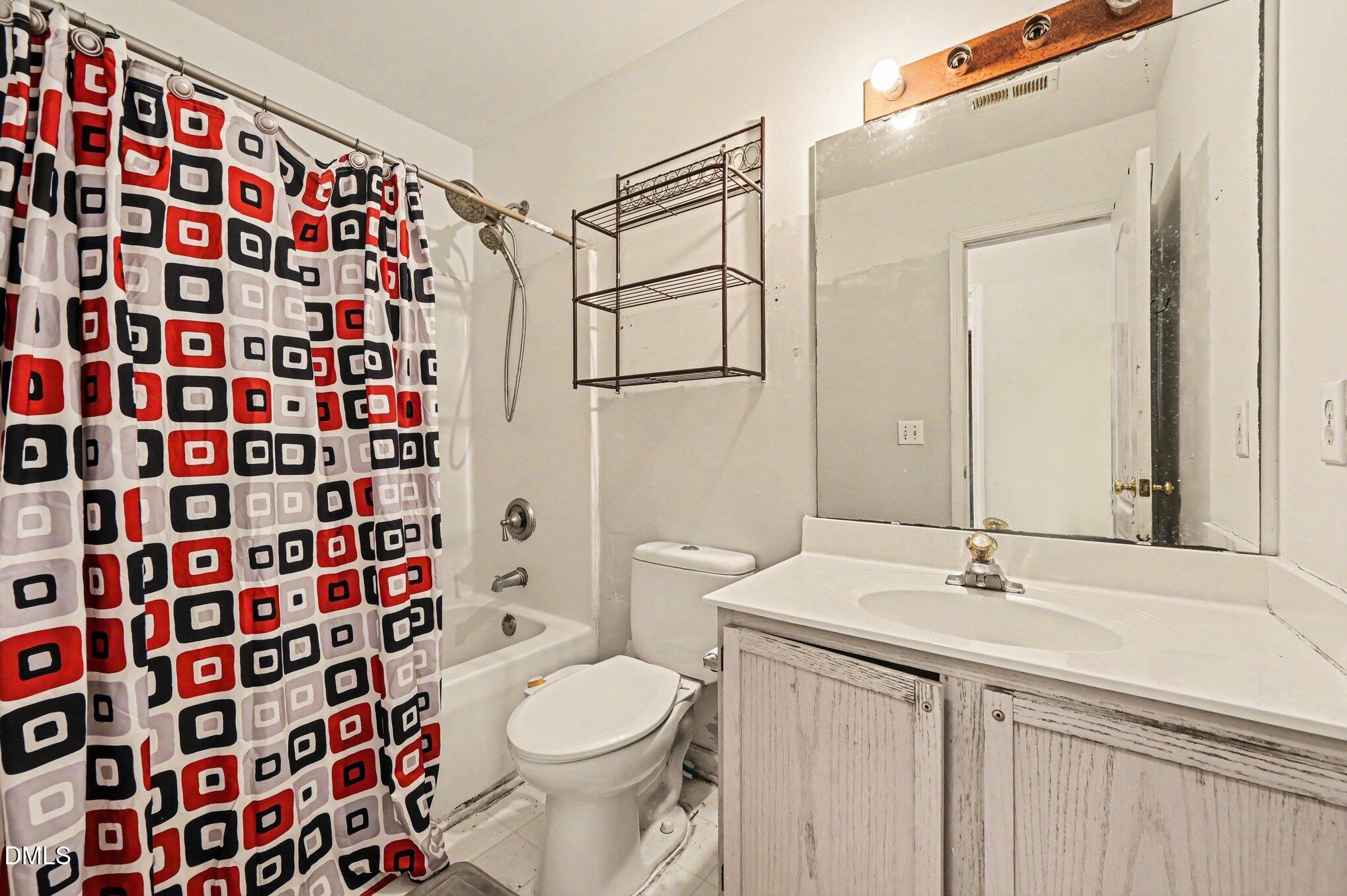 5115 Cardinal Grove Boulevard Raleigh, NC 27616 - Photo 17 of 36 a bathroom with a sink a toilet and shower