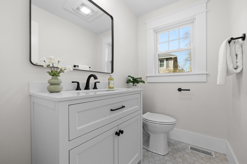 26 Holman Road Newton, MA 02466 - Photo 12 of 33 a bathroom with a toilet sink and mirror