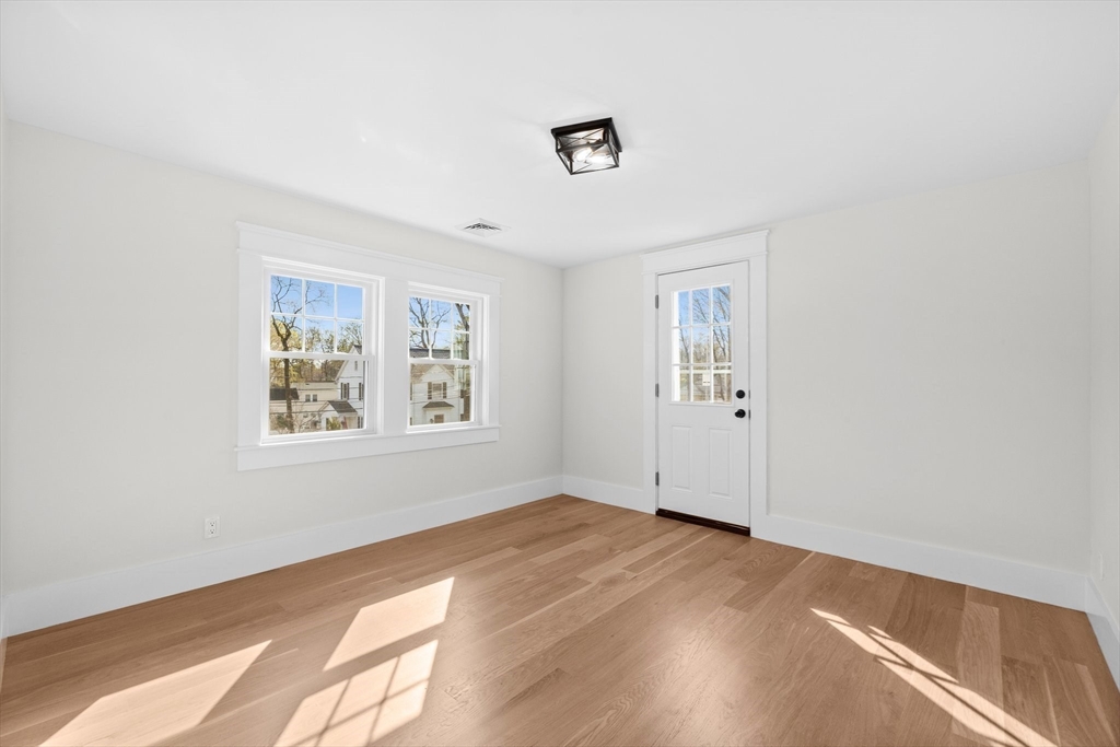 26 Holman Road Newton, MA 02466 - Photo 22 of 33 an empty room with wooden floor and windows