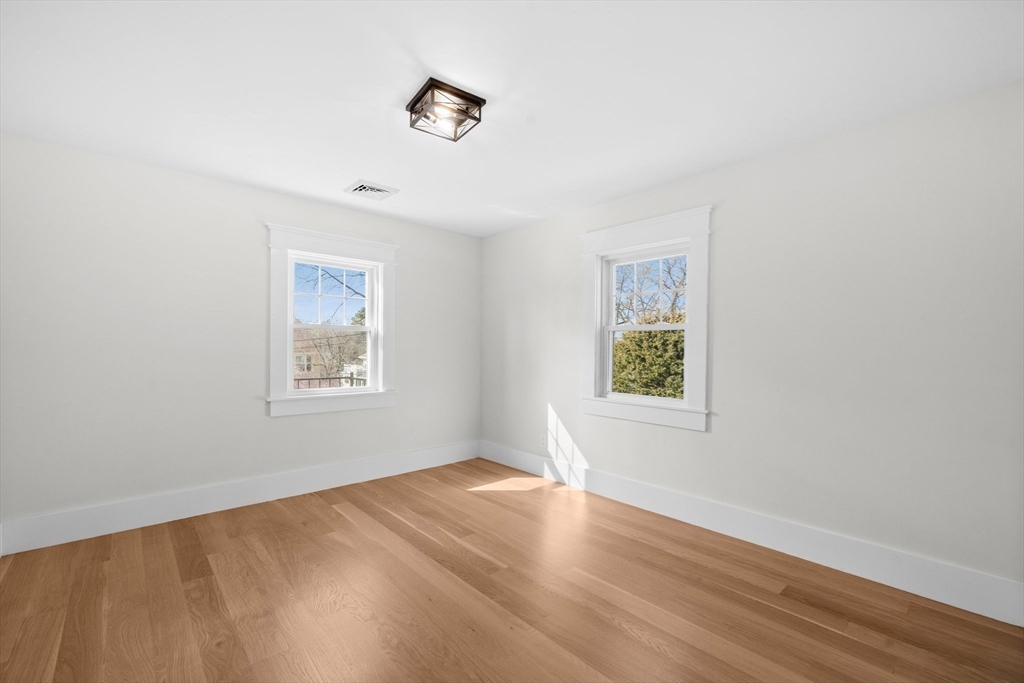 26 Holman Road Newton, MA 02466 - Photo 23 of 33 a view of an empty room with wooden floor and a window