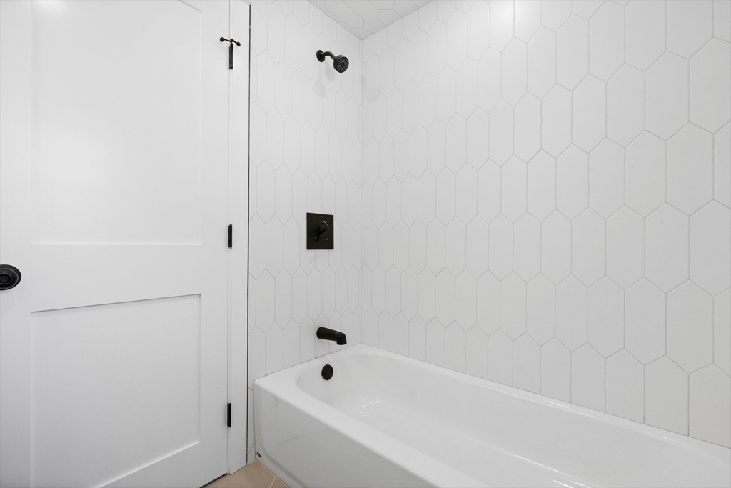 26 Holman Road Newton, MA 02466 - Photo 25 of 33 a bathroom with a bathtub and shower