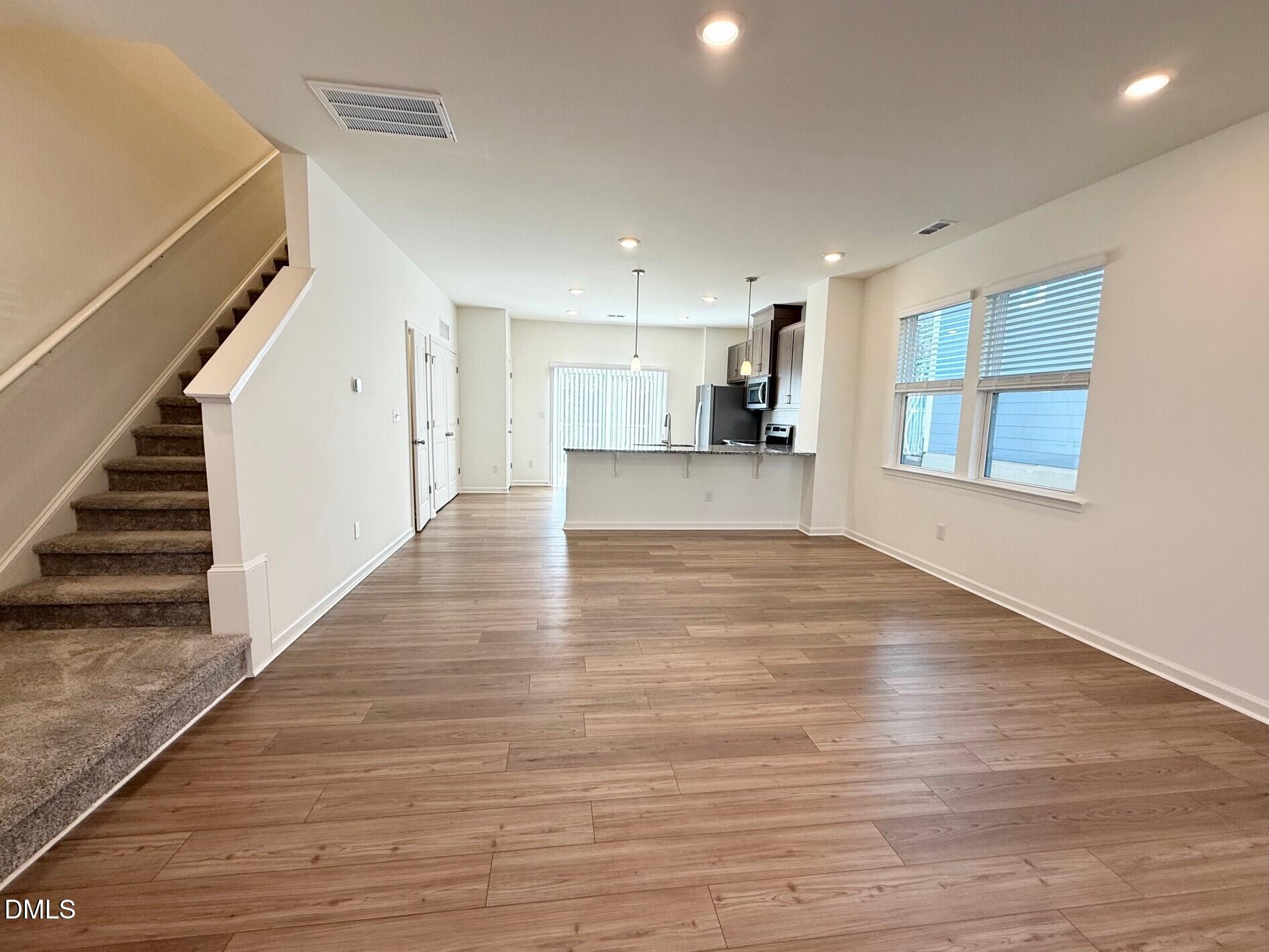332 Hacksaw Trail Raleigh, NC 27610 - Photo 12 of 29 a view of a kitchen with wooden floor and stairs