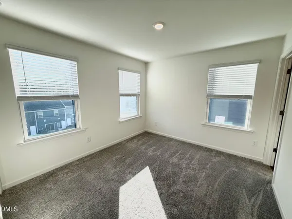 a view of wooden floor and windows in a room