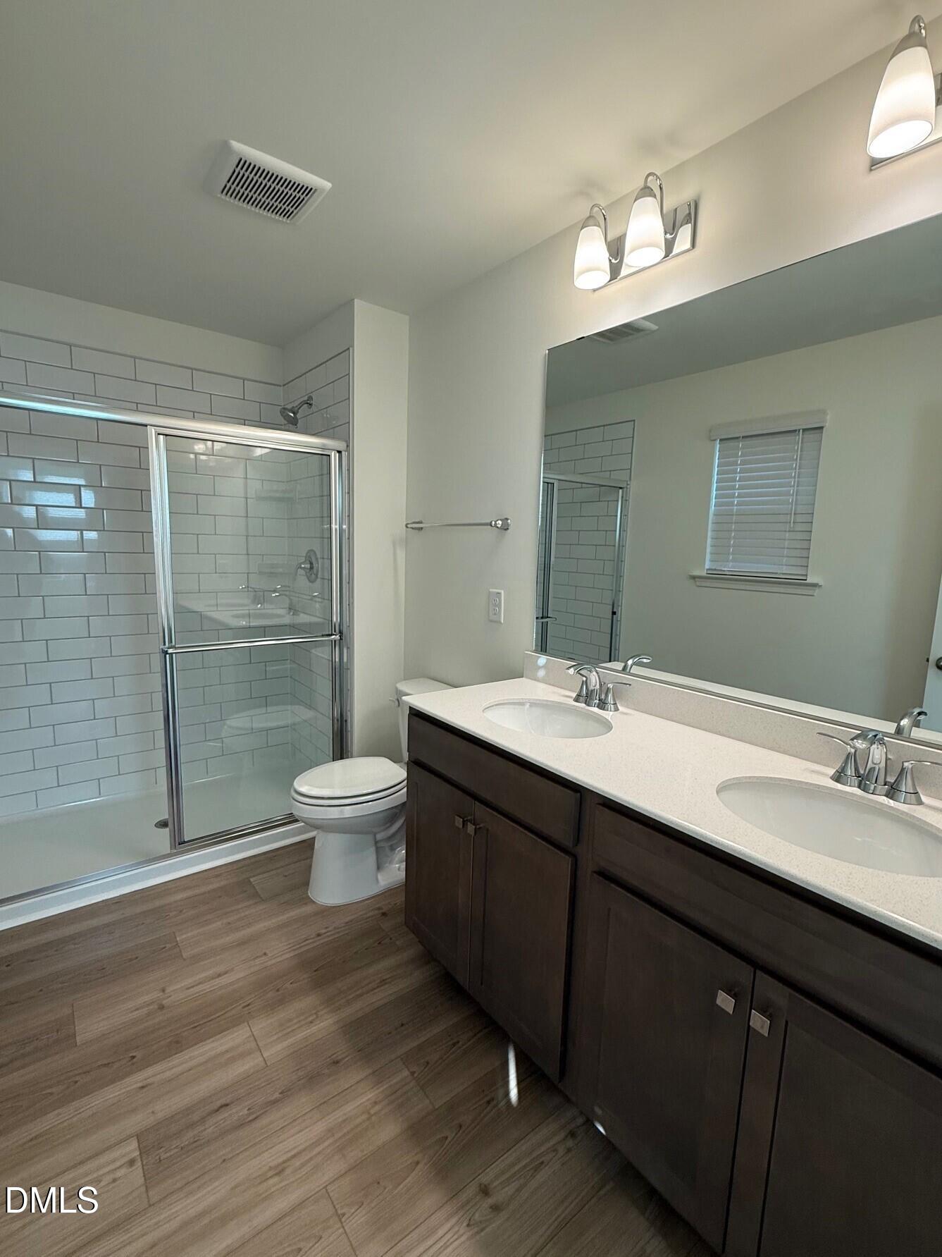 332 Hacksaw Trail Raleigh, NC 27610 - Photo 19 of 29 a bathroom with a double vanity sink toilet and shower