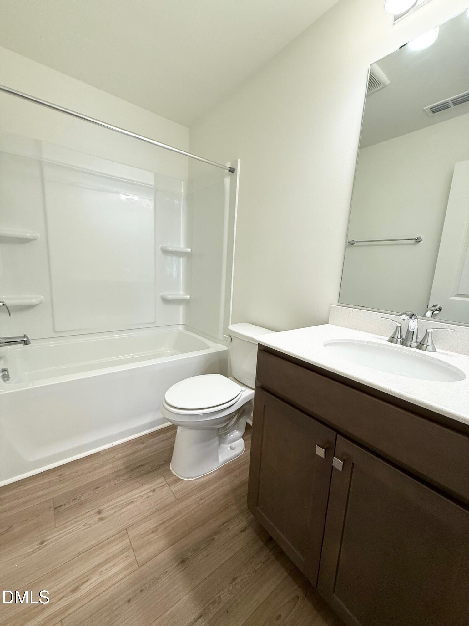 332 Hacksaw Trail Raleigh, NC 27610 - Photo 24 of 29 a bathroom with a sink a toilet and a bathtub