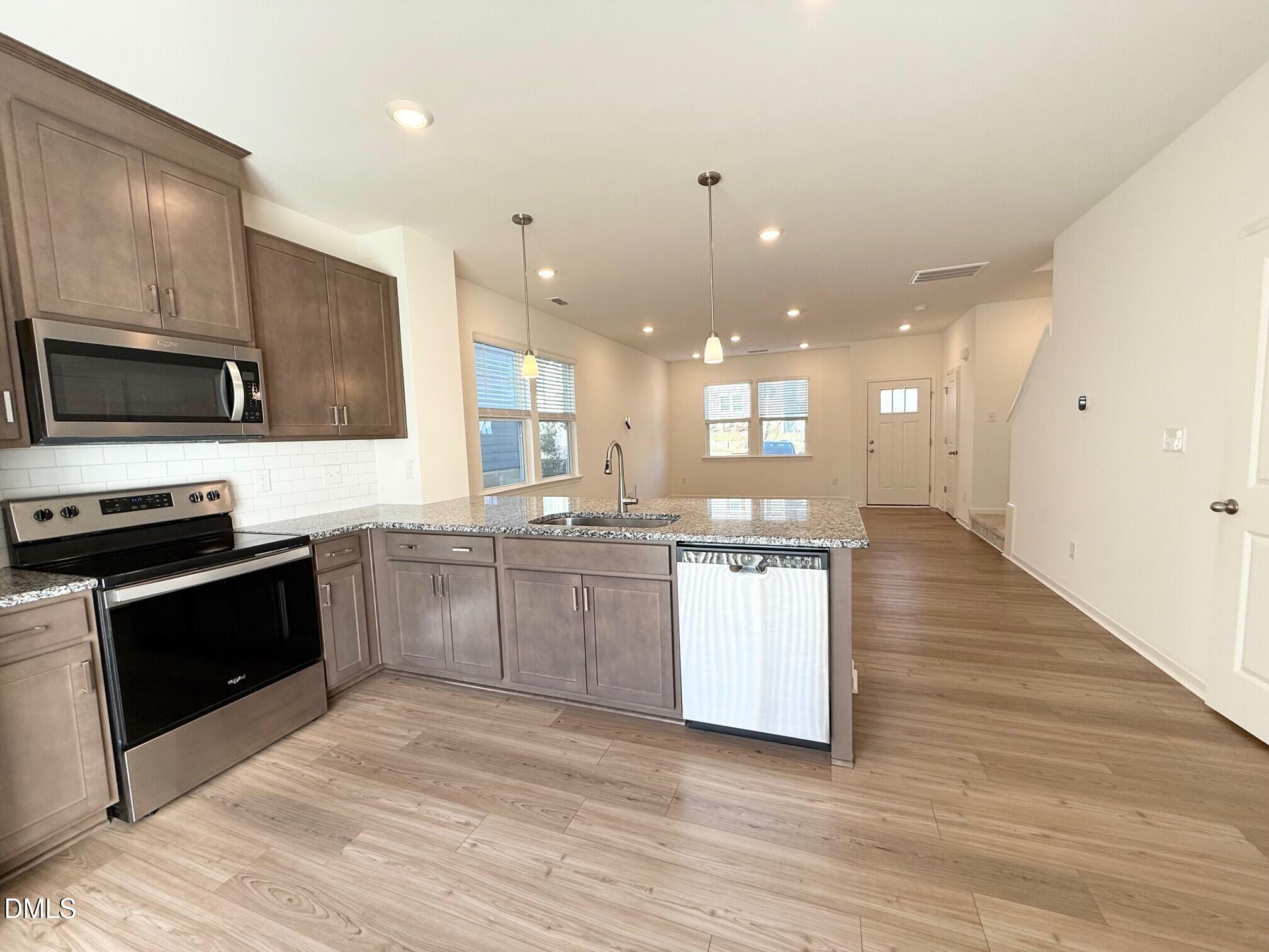 332 Hacksaw Trail Raleigh, NC 27610 - Photo 8 of 29 a large kitchen with kitchen island a sink stainless steel appliances and cabinets