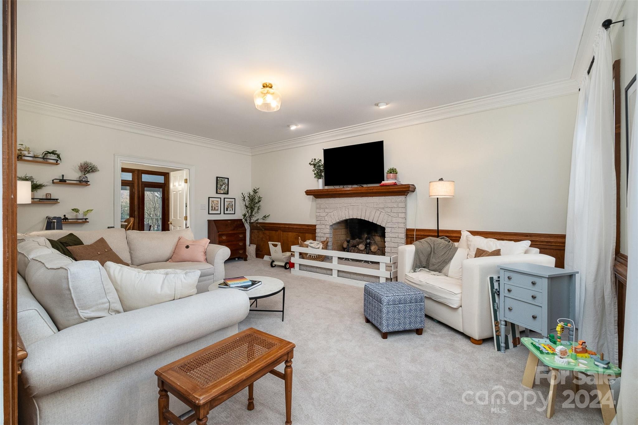 10264 Foxhall Drive Charlotte, NC 28210 - Photo 13 of 26 a living room with furniture a fireplace and a flat screen tv