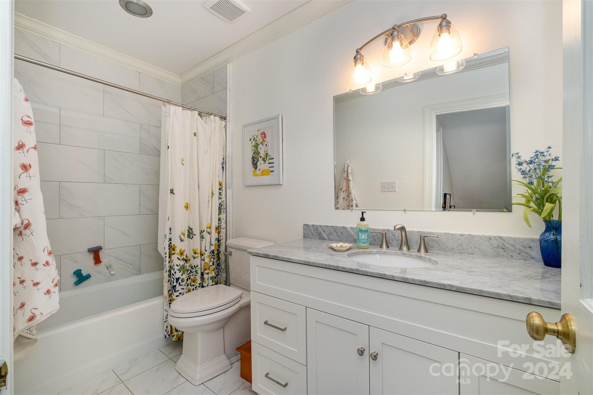 10264 Foxhall Drive Charlotte, NC 28210 - Photo 19 of 26 a bathroom with a granite countertop sink a toilet and a bathtub