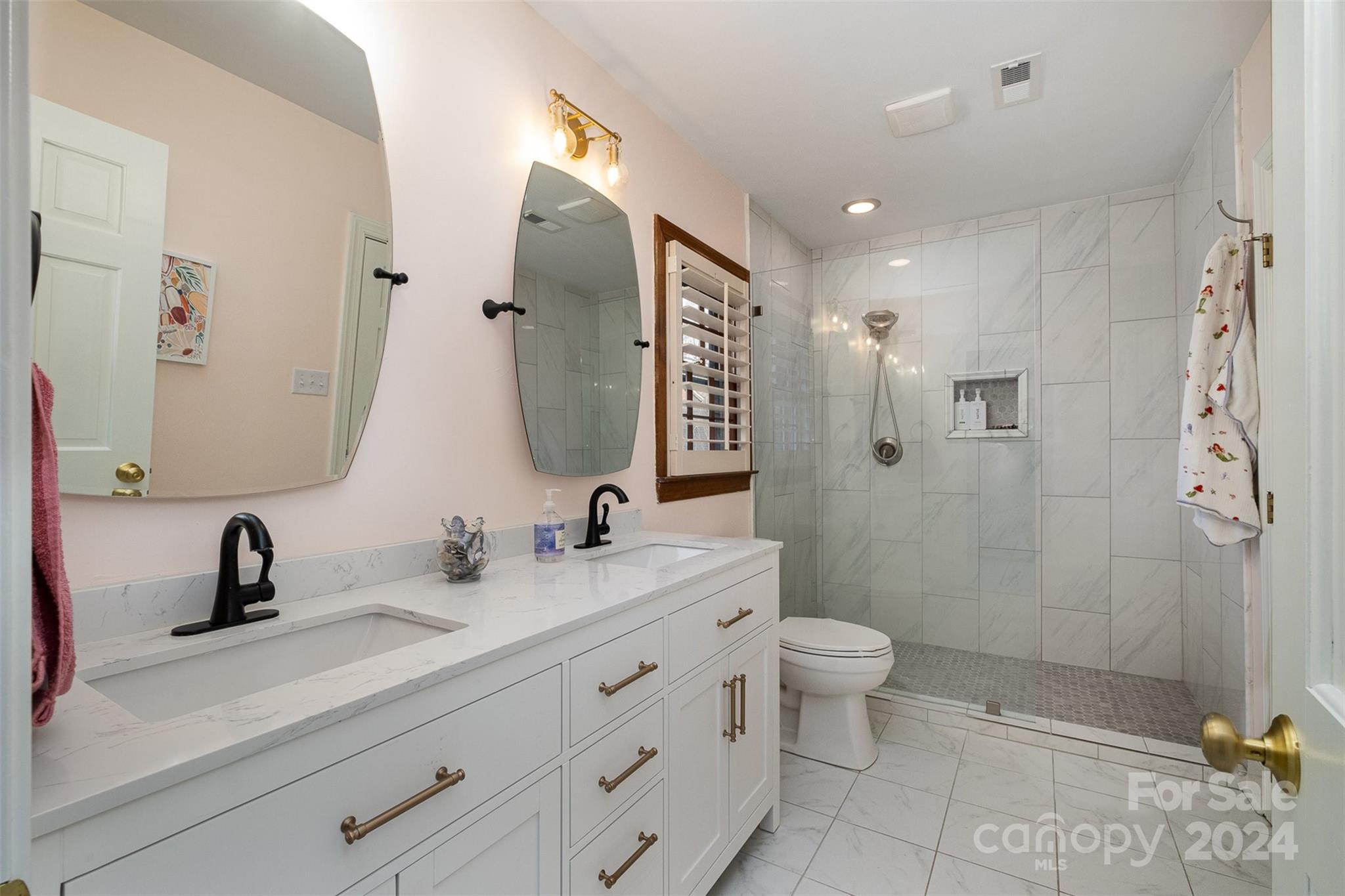 10264 Foxhall Drive Charlotte, NC 28210 - Photo 20 of 26 a bathroom with a double vanity sink toilet and shower