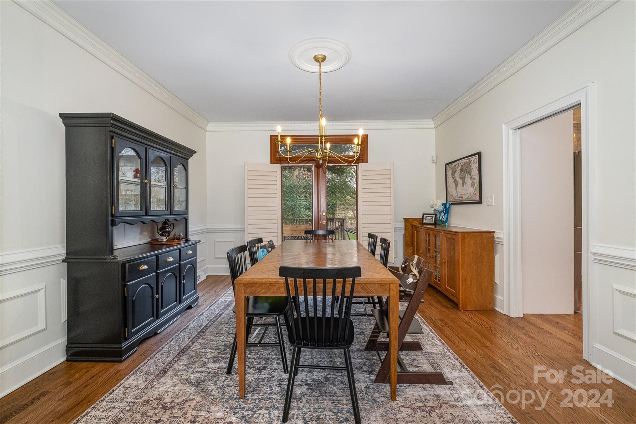 10264 Foxhall Drive Charlotte, NC 28210 - Photo 10 of 26 a dining room with furniture a chandelier and wooden floor