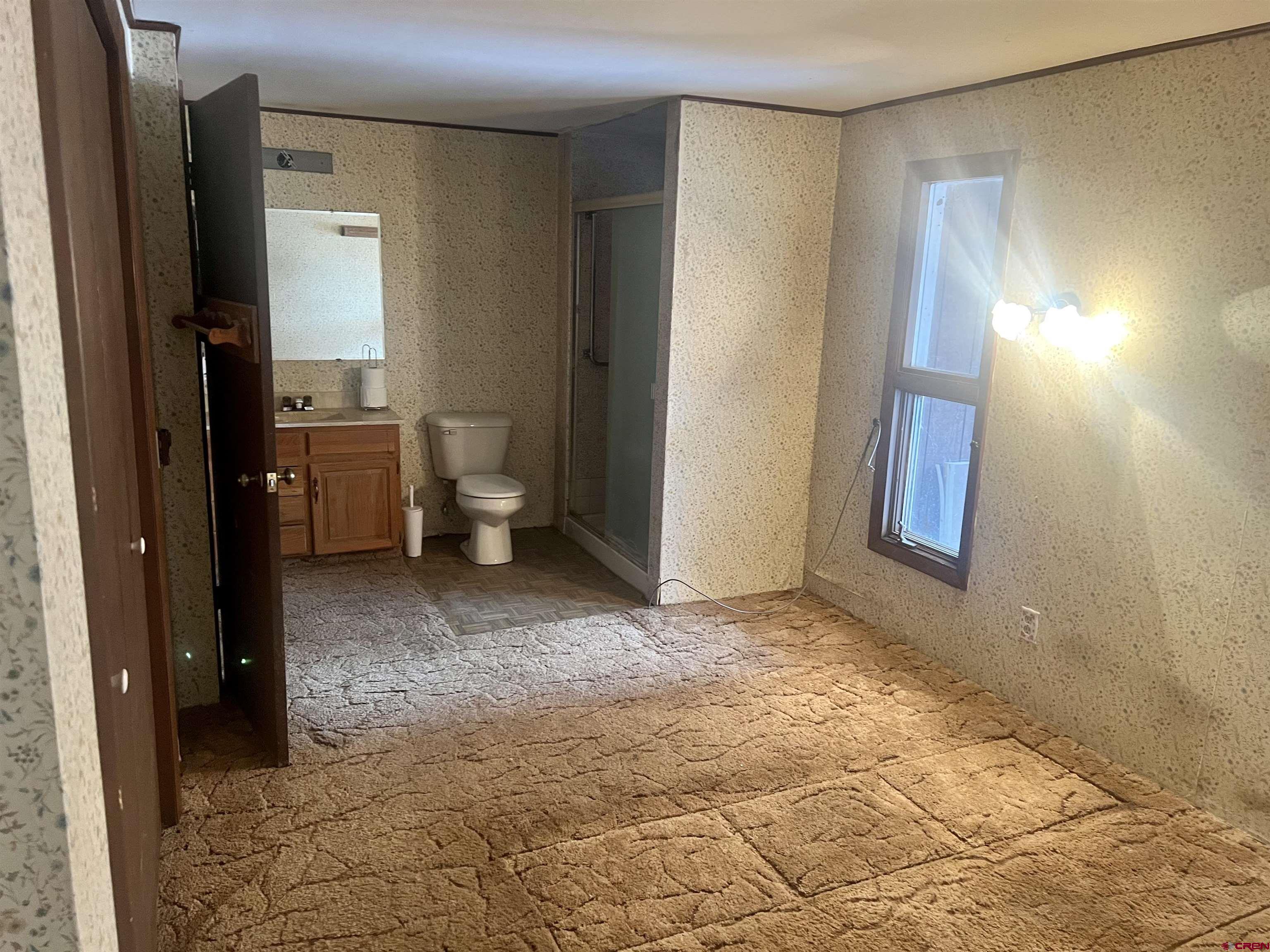 23152 Ute Trail Road Cedaredge, CO 81413 - Photo 14 of 25 a view of a room with window and hardwood floor
