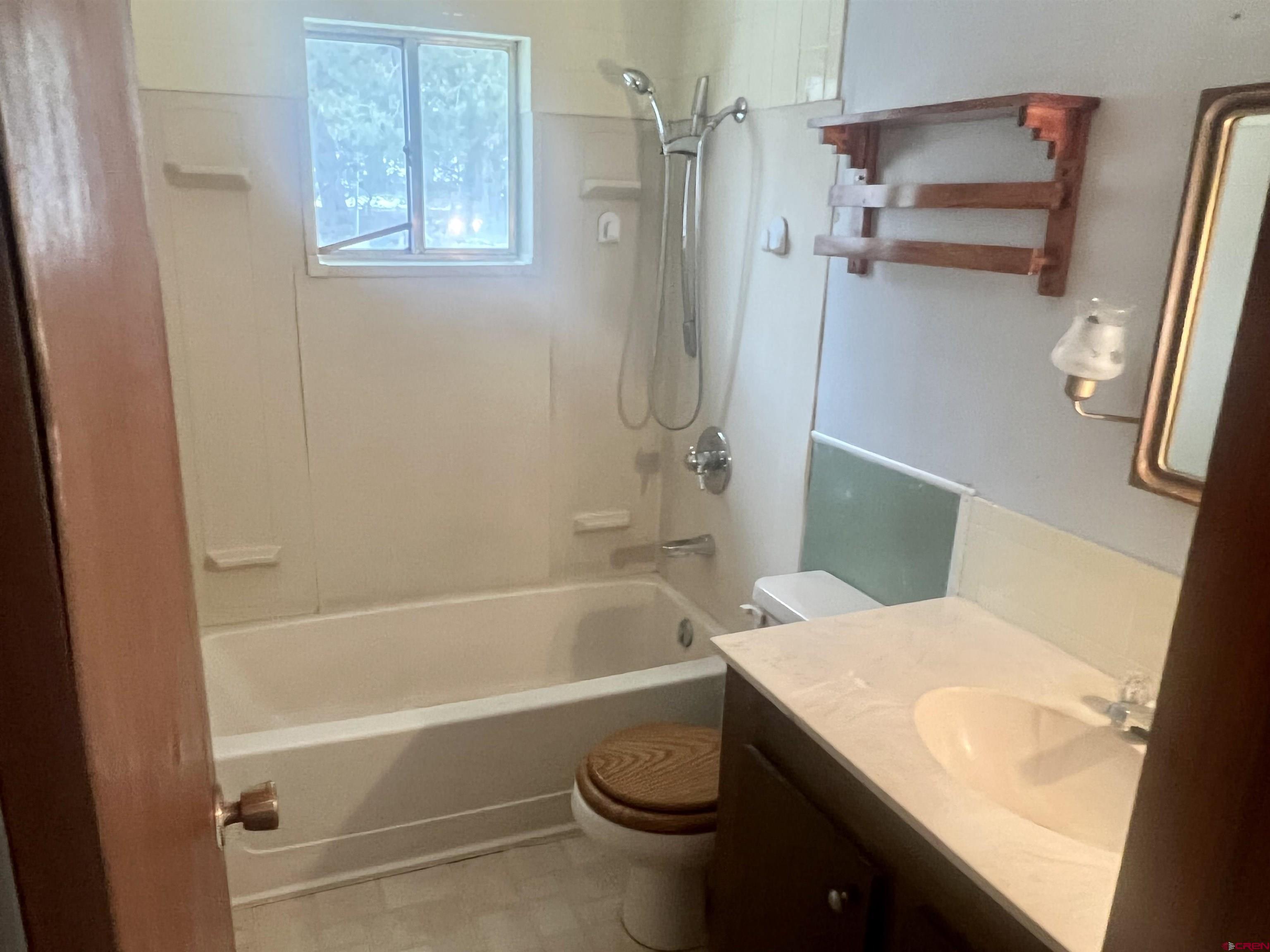 23152 Ute Trail Road Cedaredge, CO 81413 - Photo 21 of 25 a bathroom with a sink a toilet and shower