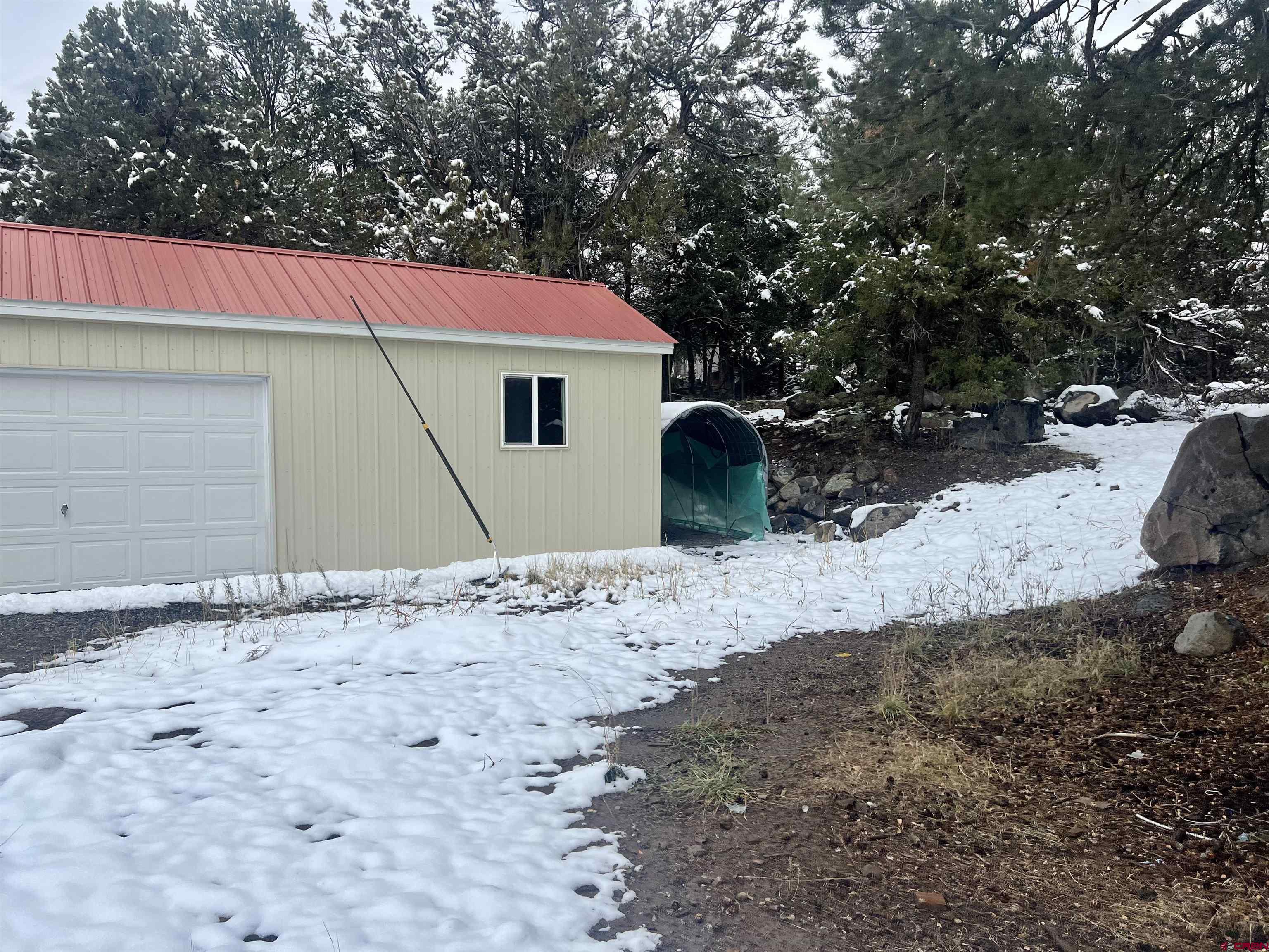 23152 Ute Trail Road Cedaredge, CO 81413 - Photo 7 of 25 a view of a dry yard with a tree