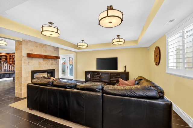714 Draper Heights Way Draper, UT 84020 - Photo 49 of 88 Living area with a raised ceiling and a multi sided fireplace