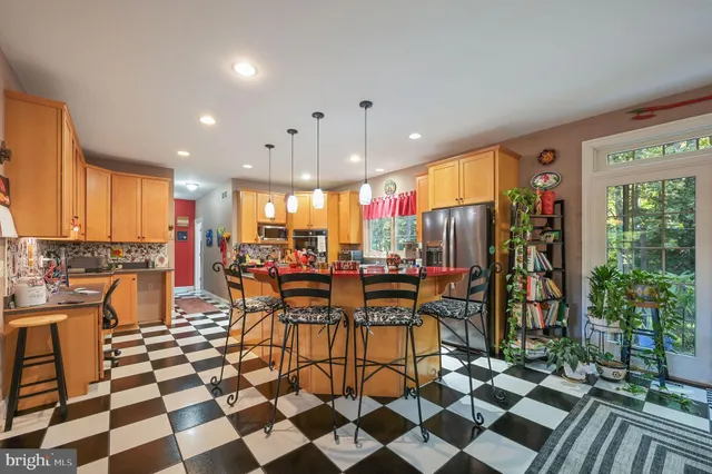 a view of a living room and kitchen with a floor to ceiling window