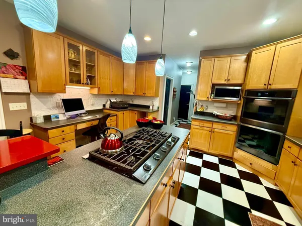 a view of a living room and kitchen with a floor to ceiling window