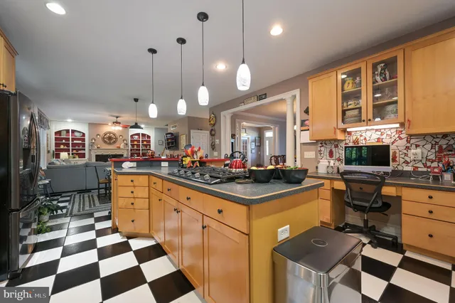 a kitchen with stainless steel appliances a stove a sink a refrigerator and cabinets