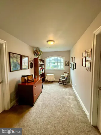 a spacious bedroom with a bed and dresser with mirror