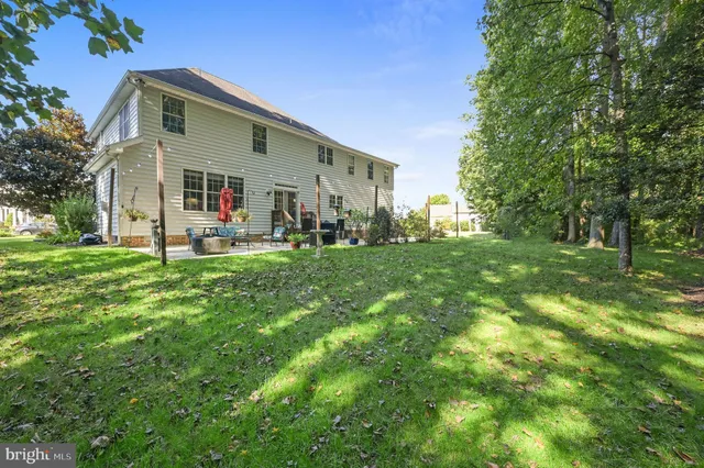 a front view of house with yard and trees