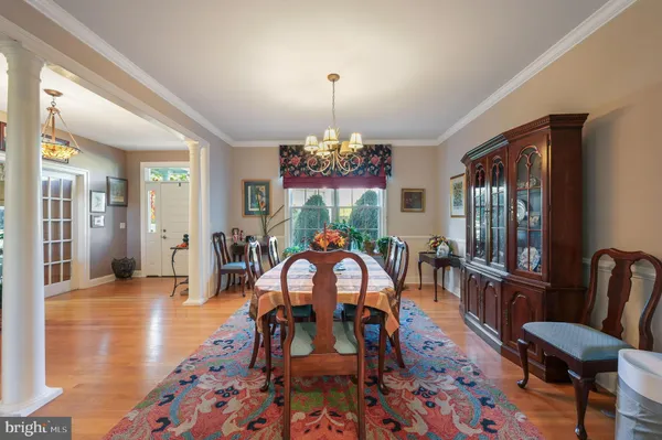 a view of a dining room with furniture and chandelier