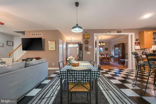 a living room with furniture a rug and a chandelier