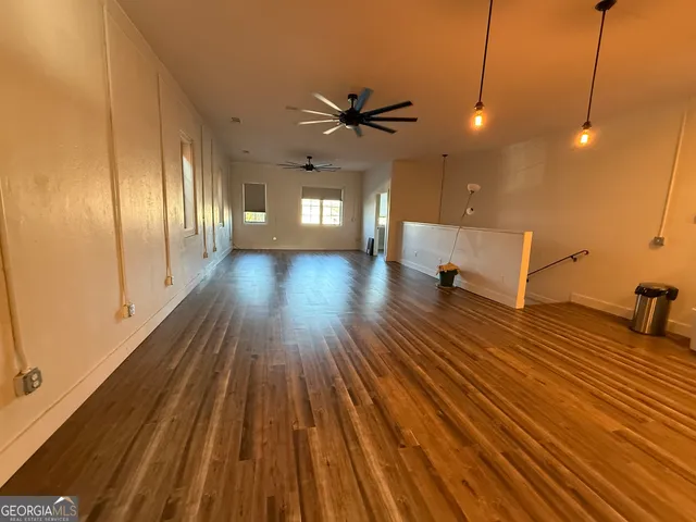 a view of a room with wooden floor